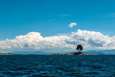 Scenic view of sea against blue sky