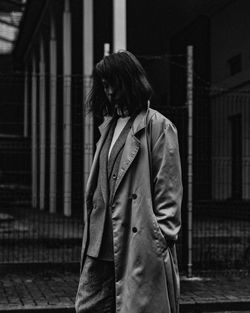 Rear view of woman standing on street in city at night