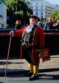 Full length of man standing on street in city