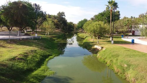 Scenic view of swimming pool by lake against sky