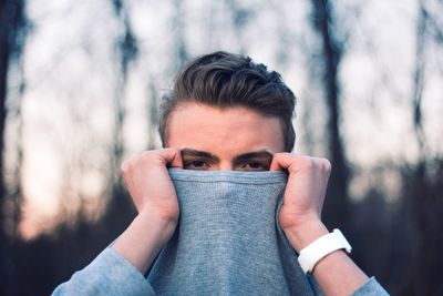 Close-up portrait of man holding t-shirt