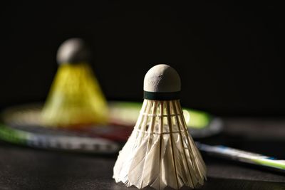 Badminton racket and shuttle in closeup photography.