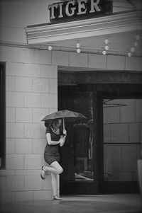 Full length of woman standing by railing