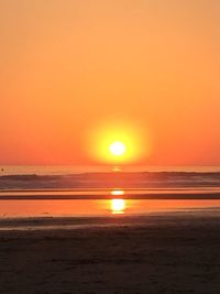 Scenic view of sea against orange sky