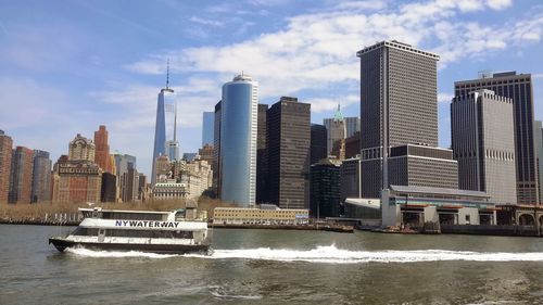 View of skyscrapers against cloudy sky