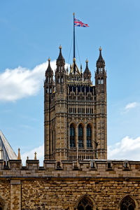 Low angle view of westminster abbey against blue sky