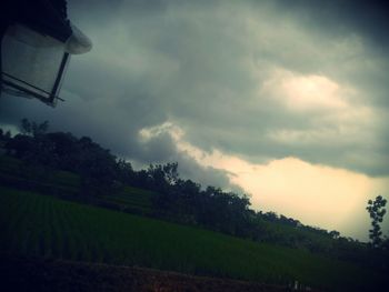 Scenic view of field against sky at sunset