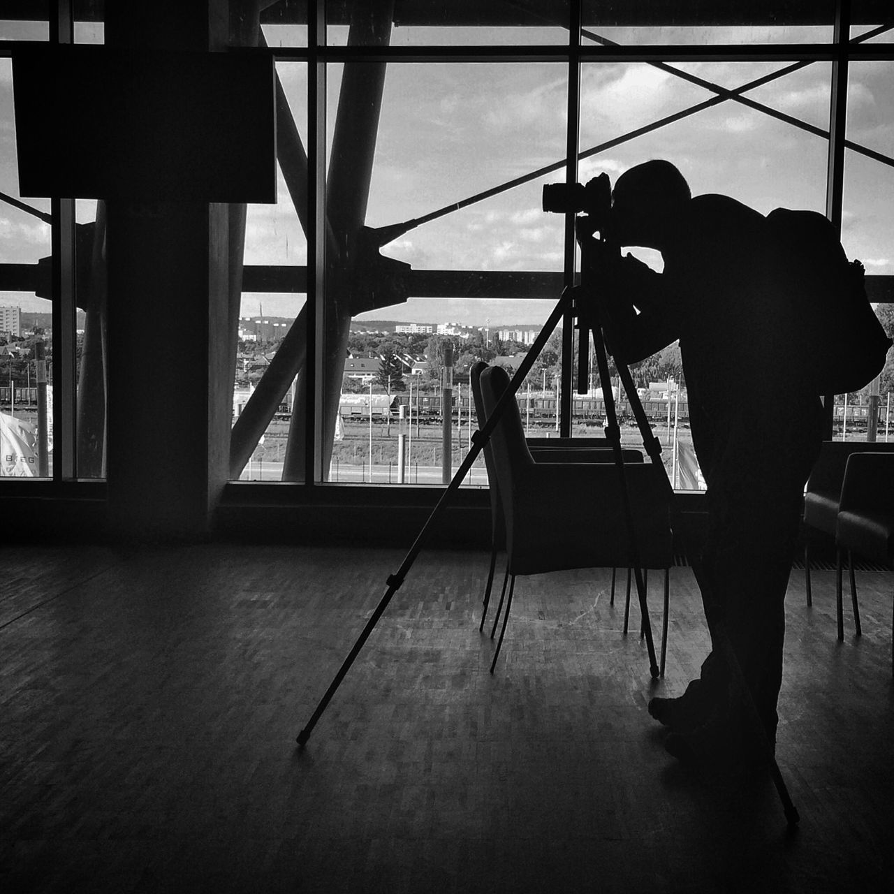 indoors, silhouette, men, transportation, lifestyles, sitting, leisure activity, window, glass - material, person, rear view, full length, travel, built structure, mode of transport, transparent, technology