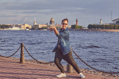 Woman standing in city at waterfront