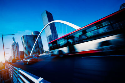 Blurred motion of bridge and buildings against sky