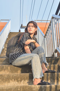 Portrait of young woman sitting on staircase