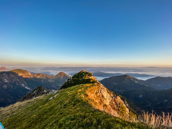 Scenic view of mountains against clear blue sky