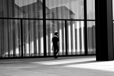Rear view of man walking in building