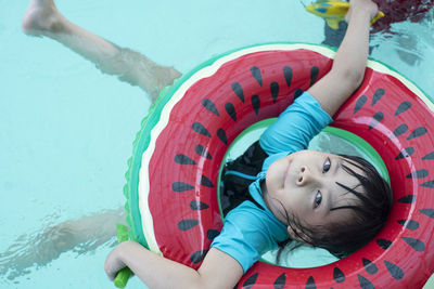 High angle portrait of cute girl in swimming pool