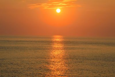 Scenic view of sea against orange sky