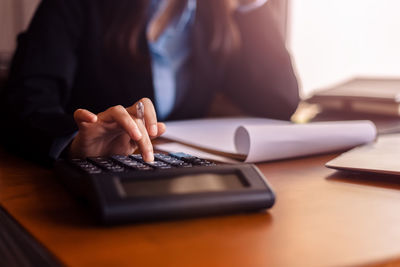 Midsection of businesswoman working in office