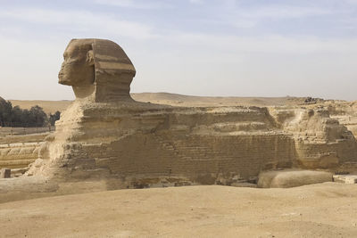 Statue of rock formations against sky