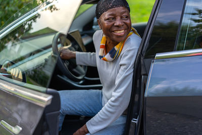Portrait of young man sitting in car