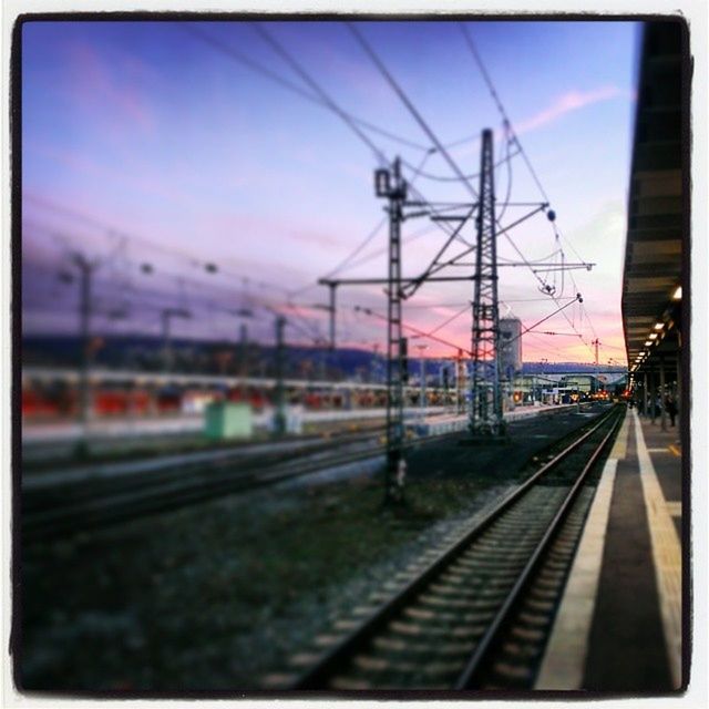 railroad track, transportation, rail transportation, public transportation, railroad station platform, railroad station, sky, train - vehicle, train, power line, mode of transport, passenger train, travel, electricity pylon, railway track, public transport, electricity, cloud - sky, dusk, auto post production filter