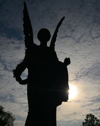 Silhouette man hand against sky at night