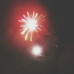 Low angle view of firework display at night