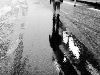 Reflection of people in puddle