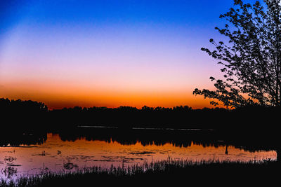 Scenic shot of calm lake at sunset