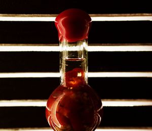 Close-up of red wineglass against black background