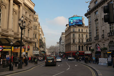 Vehicles on road along buildings