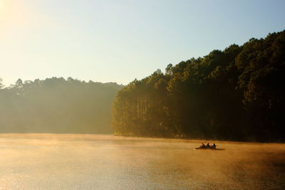 Scenic view of river against clear sky during sunset