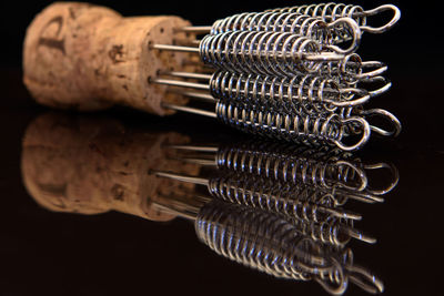 Close-up of metal object on table against black background