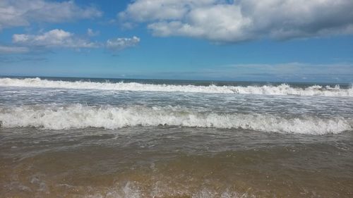 Scenic view of sea against cloudy sky