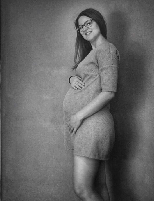 one person, standing, young adult, beautiful woman, studio shot, beauty, young women, pregnant, portrait, one young woman only, one woman only, full length, beautiful people, indoors, smiling, looking at camera, only women, lifestyles, adult, women, adults only, abdomen, people, day