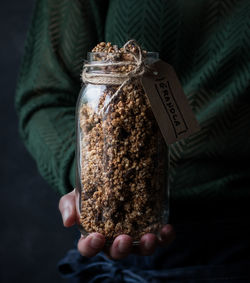 Close-up of hand holding jar