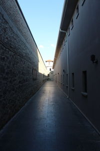 Narrow alley amidst buildings against sky