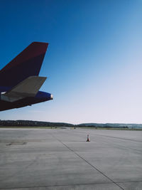 View of airport runway against clear blue sky