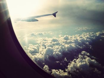 Cropped image of airplane flying over landscape