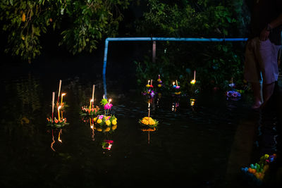 Group of people in illuminated temple at night