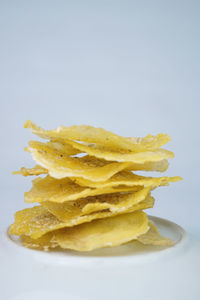 Close-up of yellow cake against white background