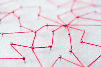 Full length shot of pink strings against white background