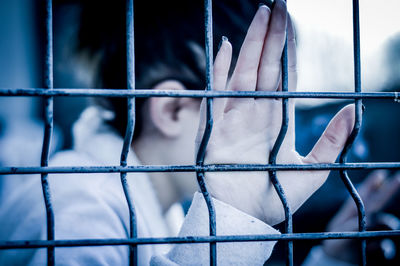 Close-up of woman holding metal grate