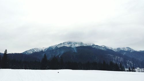 Scenic view of mountains against sky during winter