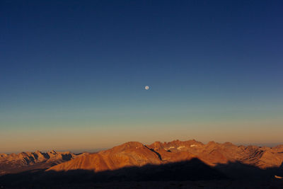 Scenic view of snowcapped mountains against clear sky