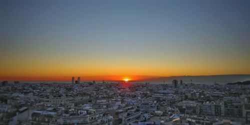 Cityscape against sky during sunset