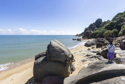 Panoramic view of rocks on beach against sky