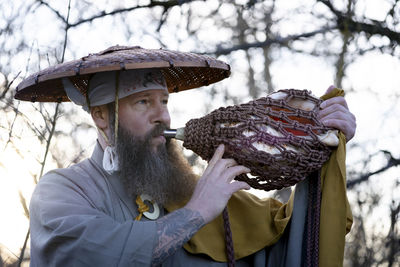 Man holding conch shell outdoors