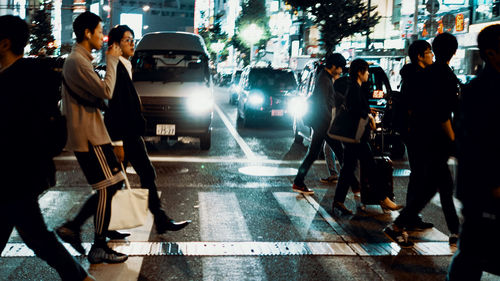 People walking on street in rain
