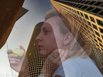 Low angle portrait of girl against sky