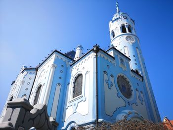 Low angle view of traditional building against blue sky