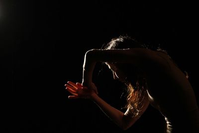 Woman dancing in darkroom